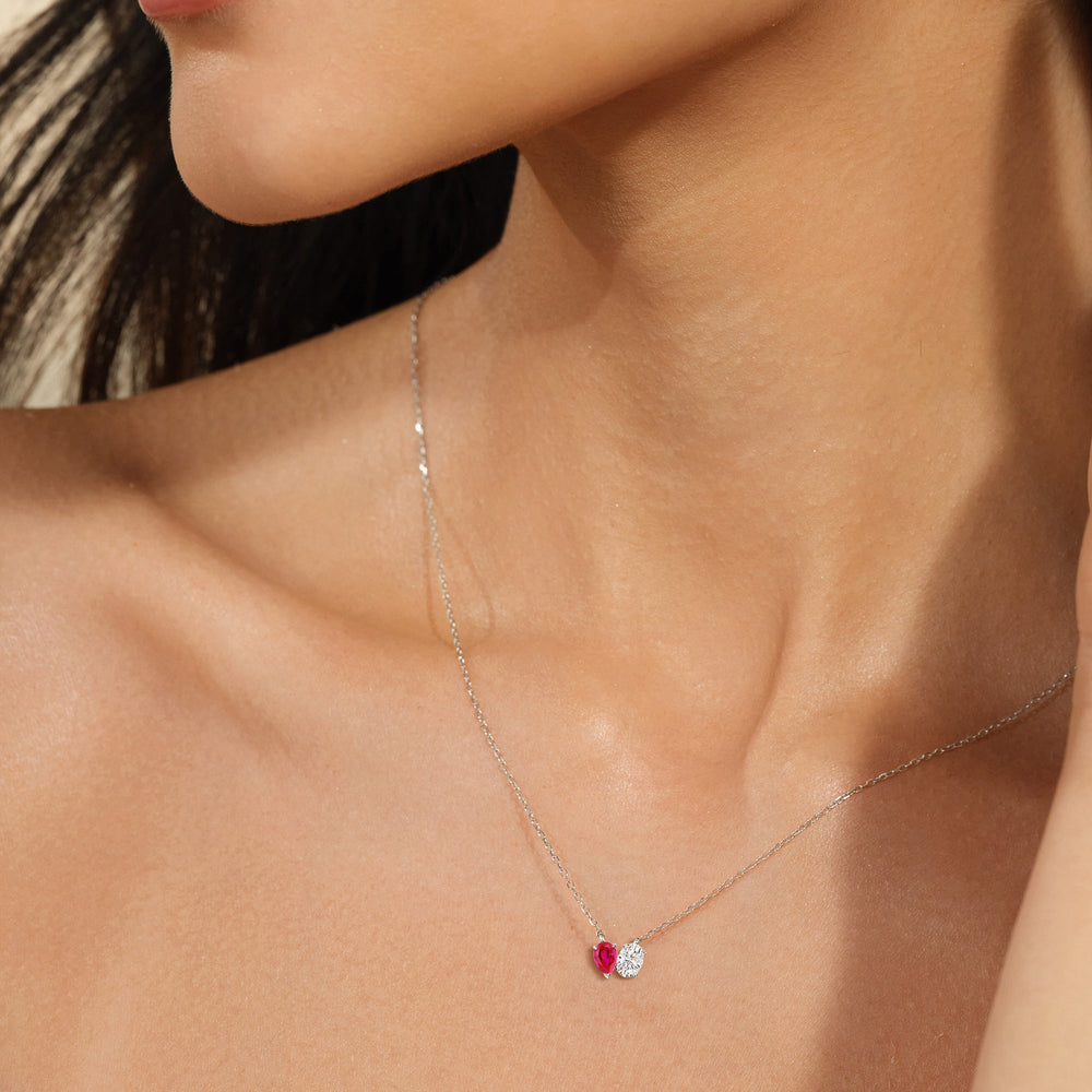 Model Wearing Toi Et Moi Created Ruby Pear and Oval Diamond Necklace view