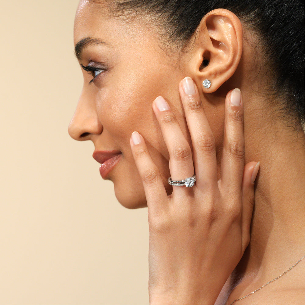 Model Wearing Delicate Pinched Cathedral Solitaire Diamond Wedding Band view