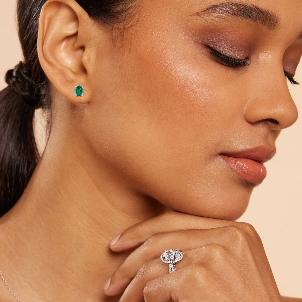 Model Wearing Oval Shape Created Emerald and Lab Diamond Classic Solitaire Under-Halo Earrings view