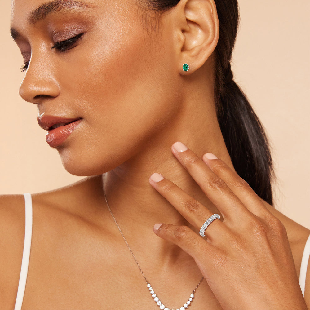 Model Wearing Oval Shape Created Emerald and Lab Diamond Classic Solitaire Under-Halo Earrings view