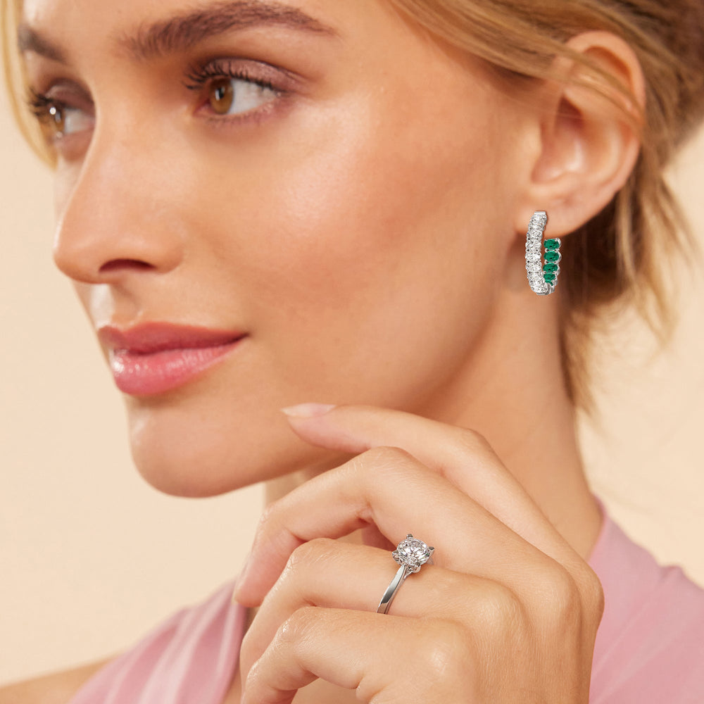 Model Wearing Inside-Out Oval Shape Diamond And Created Emerald Hoop Earring view