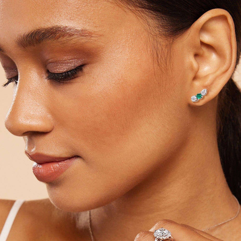 Model Wearing Trilogy Round and Pear Diamond and Created Emerald Climber Earrings view
