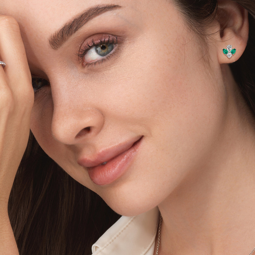 Model Wearing Classic Pear Created Emerald And Round Diamonds Cluster Earrings view