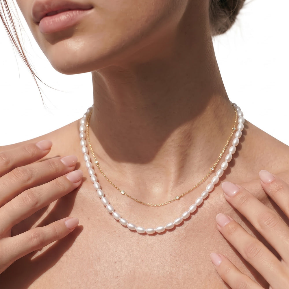 A strand of oval pearls designed to sit neatly around the neckline. A modern take on the classic pearl necklace that can be worn alone or paired with other necklaces. with 14KT White Gold Cut Diamond in 14KT White Gold view 3
