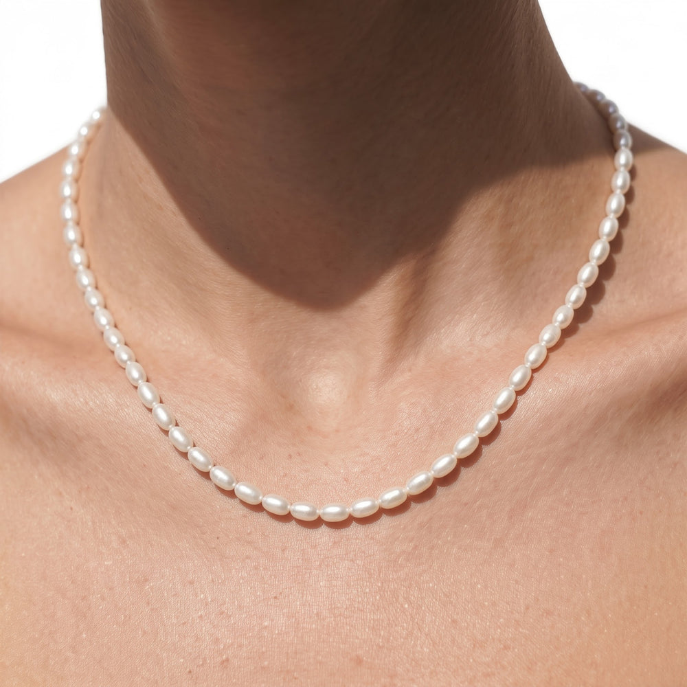 A strand of oval pearls designed to sit neatly around the neckline. A modern take on the classic pearl necklace that can be worn alone or paired with other necklaces. with 14KT Yellow Gold Cut Diamond in 14KT Yellow Gold view 2
