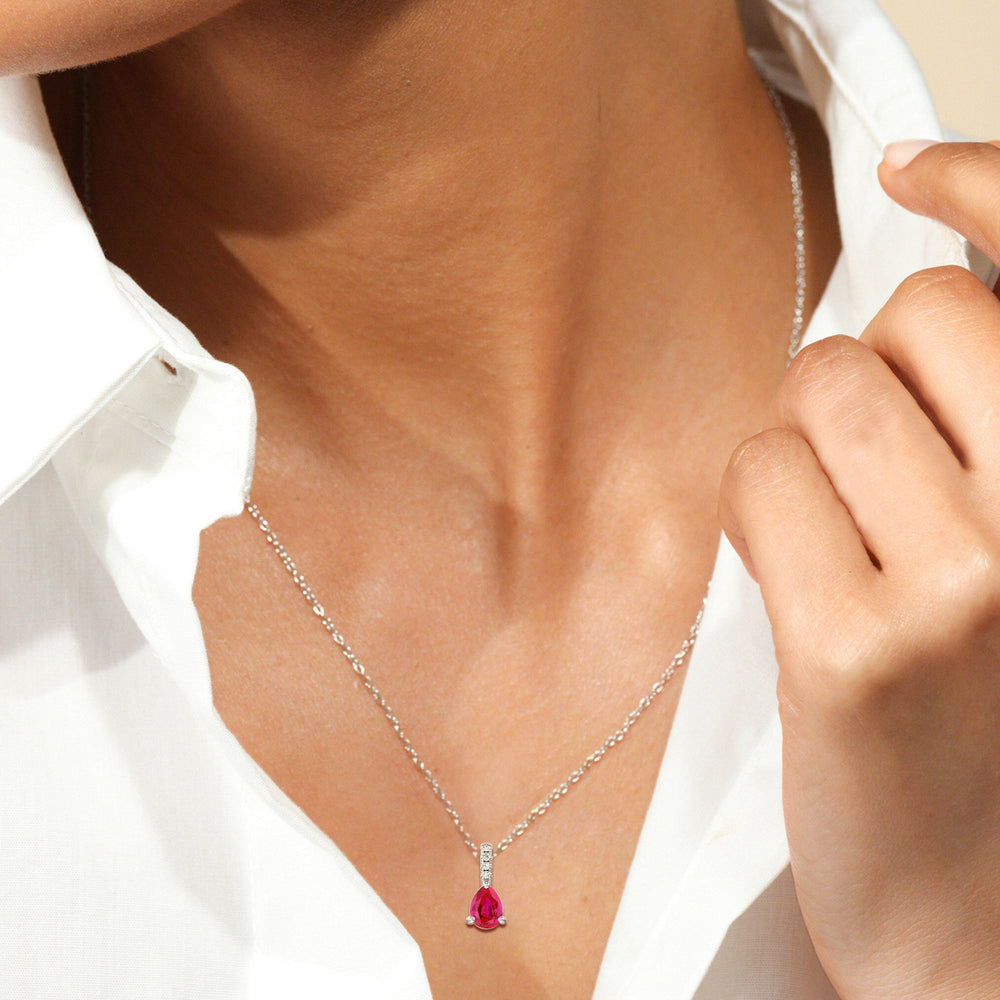 Model Wearing Pear Created Ruby and Lab Diamond Classic Solitaire Pendant With Studded Bale view