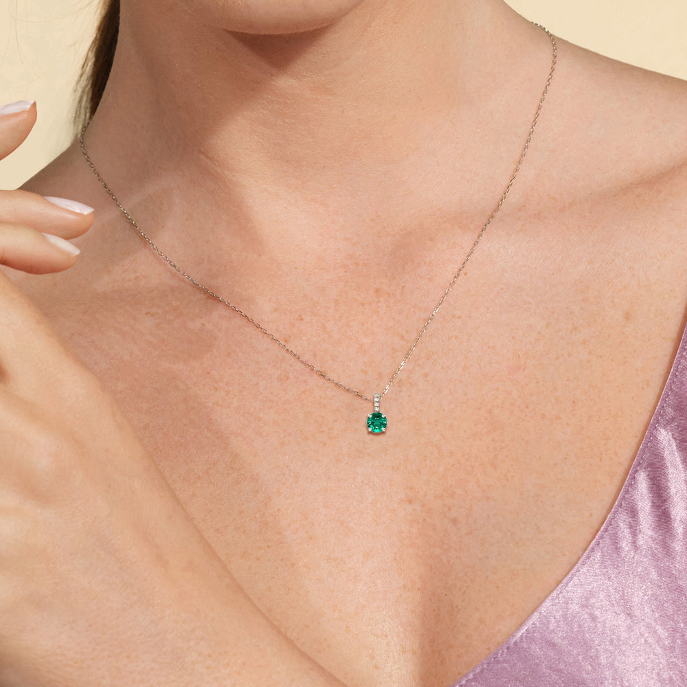 Model Wearing Round Shape Created Emerald and Lab Diamond Classic Solitaire Pendant With Studded Bale view