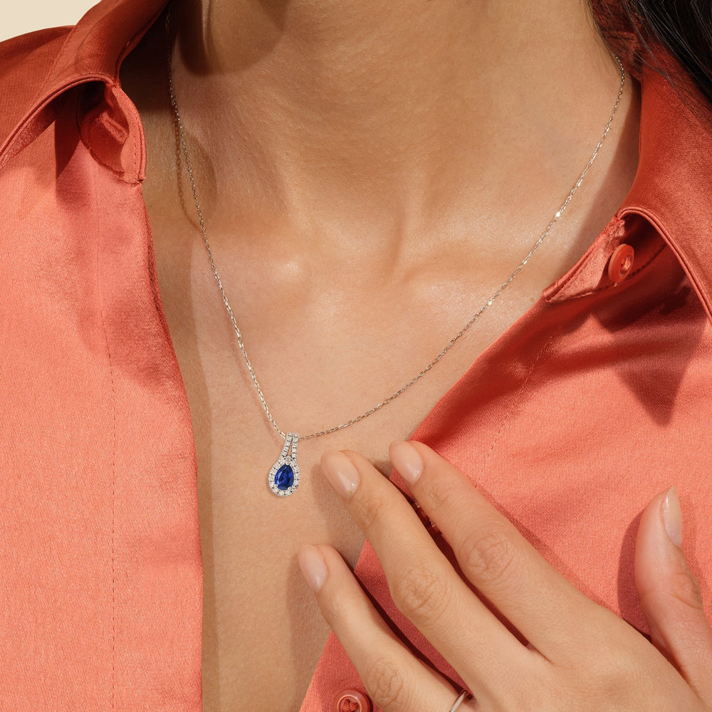 Model Wearing Pear Created Sapphire and Lab Diamond Classic Halo Pendant With Studded Split Bale view
