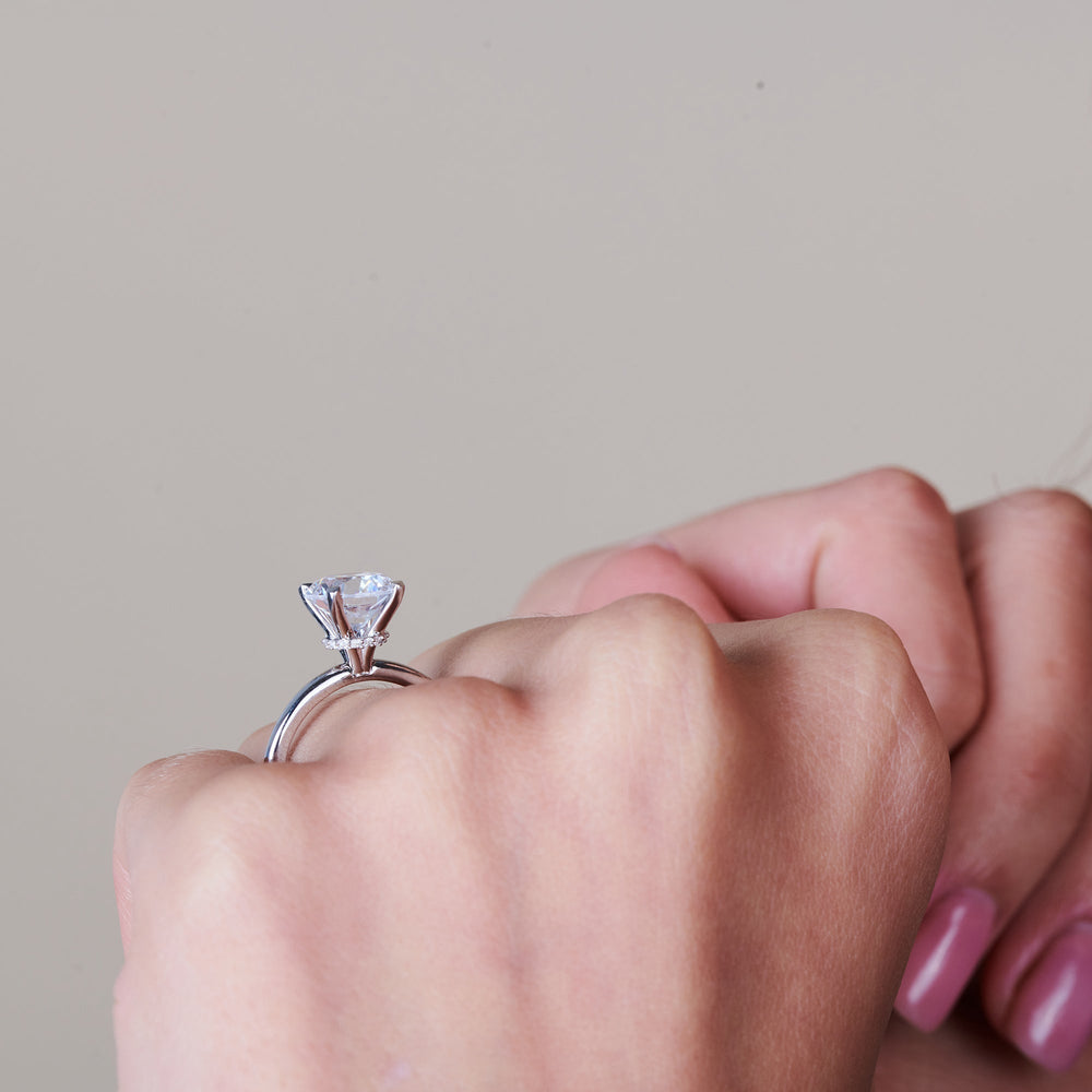 Model Wearing 2 cttw Oval Cut Modern Fine Line Hidden Halo Engagement Ring view