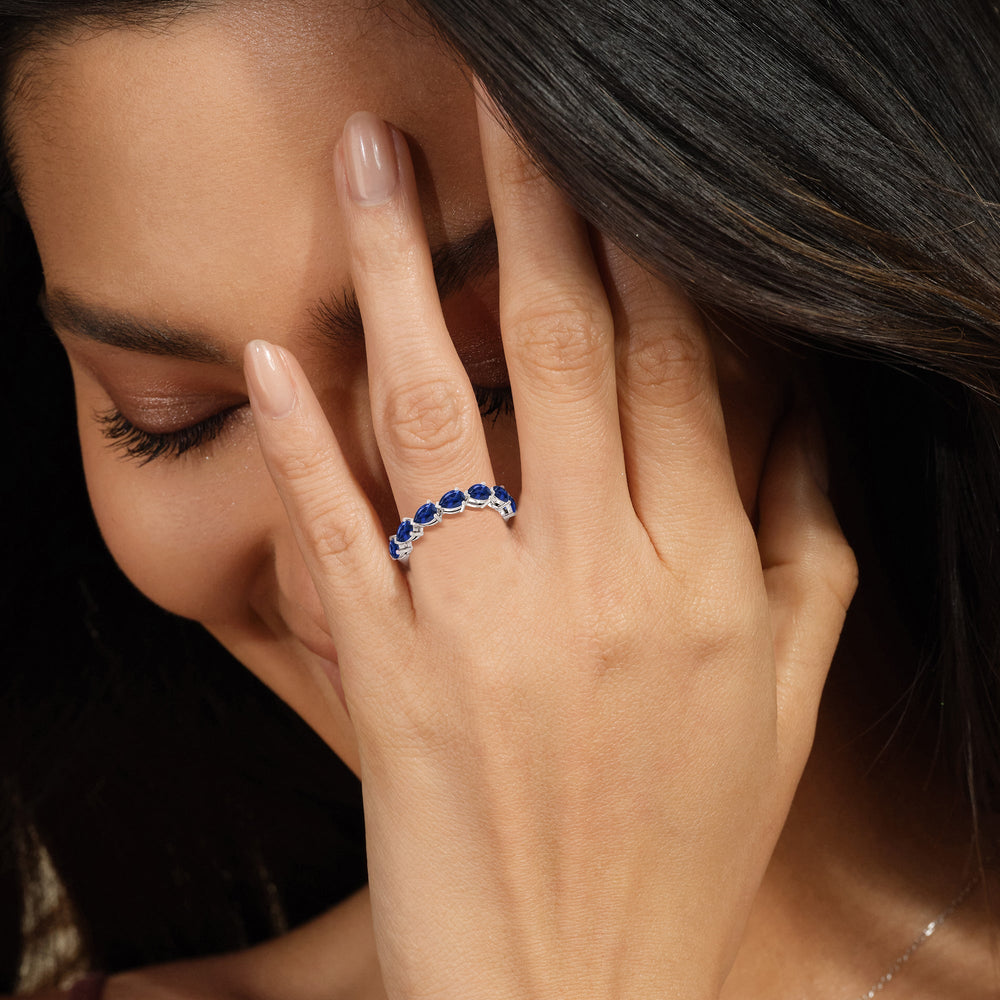 Model Wearing Trailing Created Sapphire Pear Anniversary Ring view